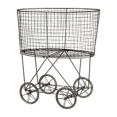 a metal wire basket with wheels on a white background