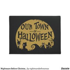 a door mat with the words our town of halloween written in black and gold on it