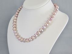 Just pearls -- without any distractions. Large pink pearls with beautiful shades of lavender and mauve strung together with a sterling silver lobster clasp closure. The pearl beads are 10 to 11 mm in size and the necklace shown is 18 inches long (46 cm). More sizes are available -- choose your perfect length from 16- to 24-inch. Free USPS first class domestic shipping. The bracelet and earrings are sold separately at these links: https://www.etsy.com/listing/732084192 https://www.etsy.com/listin Purple Single Strand Pearl Necklace, Elegant Lavender Pearl Necklace With Round Beads, Pearl Collar, Lapis Lazuli Jewelry, Pink Pearls, Freshwater Pearl Jewelry, Buy Bead, Pink Pearl, Necklace Sterling Silver