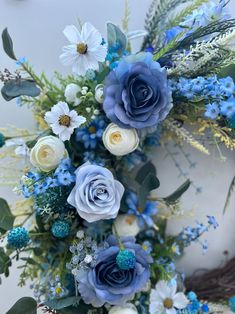 blue and white flowers are arranged in a bouquet