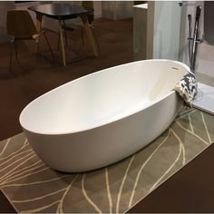 a white bath tub sitting on top of a rug