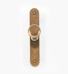 an antique brass door handle on a white background