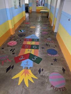 a hallway with painted numbers and stars on the floor