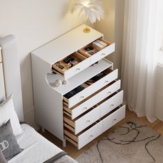 a white dresser with drawers in a bedroom