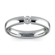 a white gold ring with a single diamond in the center and an inscription on the side