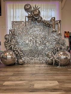 an artistic display with silver balls and balloons