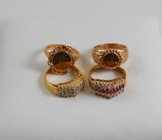 Lot of 4 14k HGE over sterling rings. All included in purchase. The gemstone rings are size 9 and the Signant rings, with an E and J are size 8 US.