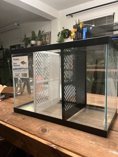 a fish tank sitting on top of a wooden table