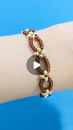 a woman's arm with a beaded bracelet on it