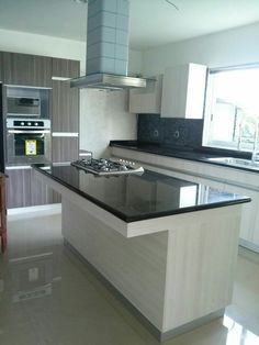 a kitchen with an island and stove top oven