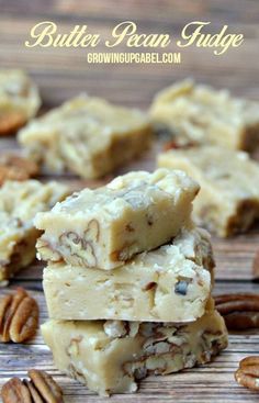 pecan fudge bars stacked on top of each other with pecans around them