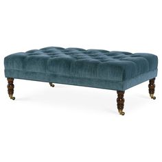 an upholstered bench with wooden legs and dark blue velvet finish, viewed from the front