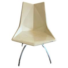 a white chair sitting on top of a metal stand