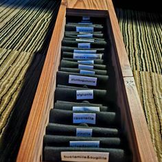 an open wooden box filled with lots of different types of sound equipment on top of a carpeted floor