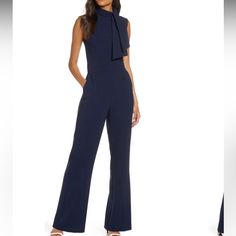 A Drapey Neck Tie Tops This Sleek Wide-Leg Jumpsuit That Amps Your Sophistication From Work To Play. 61" Length; 31" Inseam; 24" Leg Opening (Size 8) Hidden Back-Zip Closure Mock Neck With Tie Sleeveless Front Slant Pockets Lined Bodice 97% Polyester, 3% Spandex Machine Wash, Line Dry Imported Elegant Tailored Sleeveless Jumpsuits And Rompers, Blue Fitted Jumpsuits And Rompers For Work, Formal Fitted Blue Jumpsuits And Rompers, Chic Blue Jumpsuits And Rompers For Work, Elegant Overall Pantsuit For Night Out, Tailored Elegant Jumpsuits And Rompers For Office, Elegant Tailored Jumpsuits And Rompers For Spring, Elegant Tailored Office Jumpsuits And Rompers, Elegant Tailored Jumpsuits And Rompers For Night Out