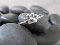 Calling all you animal lovers out there! An absolutely adorable PAW PRINT ring done in solid 925 sterling silver. Dainty, simple yet nicely detailed design, well made. Face height = 7mm. Various sizes in dropdown. Stamped 925. KEEP*IN*TOUCH FOLLOW and LIKE us on www.facebook.com/jkcorpjewelrycollection www.instagram@jkcorpjewelrycollection Sterling Silver Cat Design Rings For Anniversary, Anniversary Sterling Silver Rings With Cat Design, Paw Cat, Ring Cat, Paw Print Ring, Dog Ring, Paw Paw, Cat Ring, Cat Paw