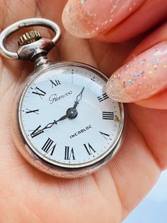 Vintage Sterling Silver Ladies Pocket Watch Sterling Remova Mechanical Hand wound pocket watch Remova vintage pocket watch with 1rd grade silver case, floral engraved decor, mechanical hand-wound movement, white enamel dial, black Roman numericals, outer minute divisions. The diameter of the watch is 2.5 cm, length of the chain 150 cm, weight is 15.3 grams. Hallmark ZI - Dutch hallmark for 925 silver. The watch dates from the middle of the 20th century. The watch runs and is otherwise in perfect Silver Pocket Watch Metal Dial Gift, Silver Pocket Watch With Metal Dial As Gift, Silver Pocket Watch With Metal Dial For Gift, Silver Automatic Pocket Watch As Gift, Silver Automatic Pocket Watch Gift, Antique Silver Watch Accessories As Gift, Antique Silver Watch Accessories For Gift, Antique Silver Watch Accessories Gift, White Chronometer Pocket Watch As Gift