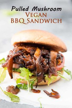 pulled mushroom vegan bbq sandwich on a bun with lettuce and bacon