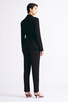 The Arabella trousers, crafted from a sculptural quality of black double crepe, these trousers offer both style and versatility. The universally flattering tailored cut provides endless styling possibilities, ensuring a seamless transition from day to evening with minimal effort. Sleek Structured Bottoms, Tailored Evening Pantsuit In Elastane, Sleek Structured Evening Pantsuit, Evening Tailored Pantsuit With Structured Boning, Modern Structured Pants For Workwear, Elegant Evening Elastane Pantsuit, Modern Tailored Structured Pants, Elegant Structured Workwear Pants, Elegant Structured Pants For Workwear