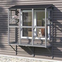 a cat sitting in the window of a house