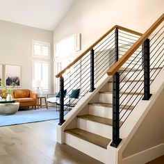 a living room filled with furniture and a stair case