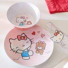 hello kitty plates and cups on a table