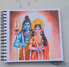 a spiral notebook with an image of the hindu god and goddess on it, sitting on top of a marble surface