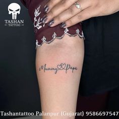 a woman's arm with the word mommy and papa written on it, in cursive font