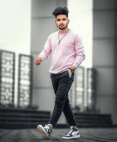 a young man is walking down the street