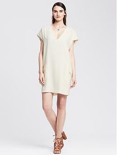 Crepe Cocoon Dress Spring V-neck Dresses With Structured Shoulders, Chic Dresses With Notched Neckline For Day Out, Chic V-neck Dress For Fall Daywear, Chic Summer Mini Dress With Structured Shoulders, Chic Mini Dress With Structured Shoulders For Summer, Chic Summer V-neck Shift Dress, Summer Workwear Mini Dress With Notched Neckline, Summer Mini Dress With Structured Shoulders, Summer Knee-length Dress With Structured Shoulders