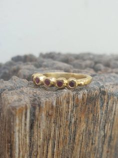 Gold Five stone dainty band ring. Gold July ruby ring. Five rubies Round Ring, Classic ring. Great gift. handmade. anniversary, valentine This is a goldfilled ring. Its a five stone ring, A delicate designer handmade ring which has a raw design. The ring is set with 5 rubies stones. You can choose you're favorite gemstone or birthstone from: blue topaz, citrine, moonstone, garnet and smoky quartz. This ring can be also be one of a stacking casual ring set. This ring is made with high quality 14k Stackable Ruby Birthstone Rings With Round Band, Stackable Ruby Birthstone Rings, Fine Jewelry Ruby Stackable Rings, Fine Jewelry Stackable Ruby Rings, Ruby Stackable Round Band Promise Rings, Ruby Birthstone Ring With Bezel Setting, Ruby Ring With Rose Cut Diamonds For Promise, Fine Jewelry Stackable Ruby Promise Ring, Ruby Stackable Rings With Birthstones