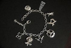 A collection of silver plated Texas themed charms have been dispersed around a shimmering silver plated bracelet chain in this handmade charm bracelet. This Texas charm bracelet is then completed with a lobster clasp and a 1/2 inch of chain at the end for adjustable sizing. Charms in this bracelet include two Texas state charms, a lone-star charm, an oil rig charm, bull charm, Texas rose charm, boot spurs charm, horseshoe with cowboy boots charm, and a long horn charm. ● Sizing ● To determine yo Personalized Symbolic Silver Bracelets, Silver Symbolic Bracelets With Dangling Charms, Symbolic Silver Bracelets With Dangling Charms, Silver Metal Chain Bracelet With Dangling Charms, Symbolic Silver Bracelet With Dangling Charms, Nickel-free Sterling Silver Symbolic Charm Bracelet, Symbolic Sterling Silver Charm Bracelet, Symbolic Nickel-free Silver Bracelets, Nickel-free Silver Charm Bracelet Gift