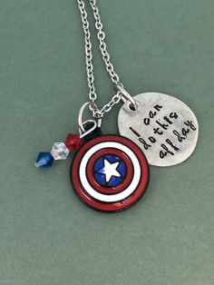 Show the Captain America pride with this hand-stamped necklace. The stamped charms are made of pewter and are approximately 3/4 inch in diameter. The chains are 20 inches long and are made of stainless steel.  The necklaces come ready to give, packaged in a hand-stamped brown cardboard box. View more items in my shop:  http://www.etsy.com/shop/dustlily Captain America Jewelry, America Pride, The Mighty Thor, Hand Stamped Necklace, California Love, Thors Hammer, Colored Gems, Photo Bracelet, Captain Marvel