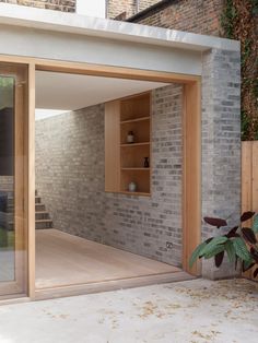 an open patio with sliding glass doors and brick walls