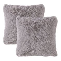 two gray pillows sitting next to each other