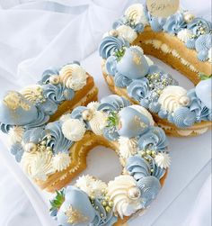 two blue and white decorated doughnuts sitting on top of a table next to each other