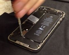 someone is removing the battery from their iphone