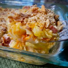 a glass casserole dish filled with macaroni and cheese covered in bacon