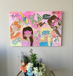 there is a painting on the wall next to a vase with flowers and other decorations