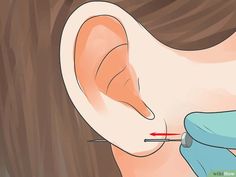 an ear being examined by a doctor injecting it with a needle into the ear