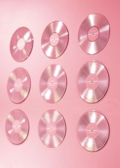 a pink background with six different types of discs on it, all in various sizes and shapes