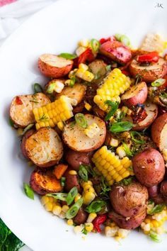 a white plate topped with potatoes and corn