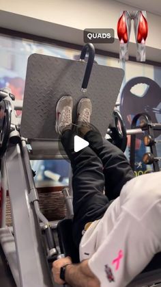 a man laying on top of a bench with his feet up in the gym machine