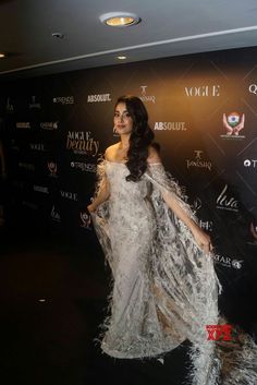 an image of a woman in white dress on the red carpet at a fashion show