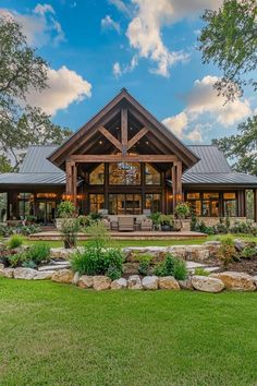 a large house with lots of windows and grass