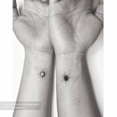 two wrist tattoos with the sun and moon on each one hand, both in black ink