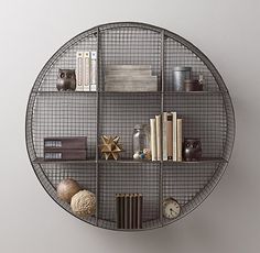 a round metal shelf with books and other items on it