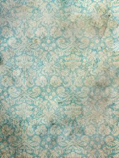 an old blue and white wallpaper with floral designs on the bottom half of it