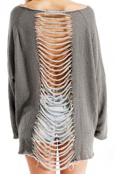 the back of a woman's sweater with ripped jeans and an open front design