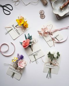 flowers and ribbons are laid out on the table for mother's day card making